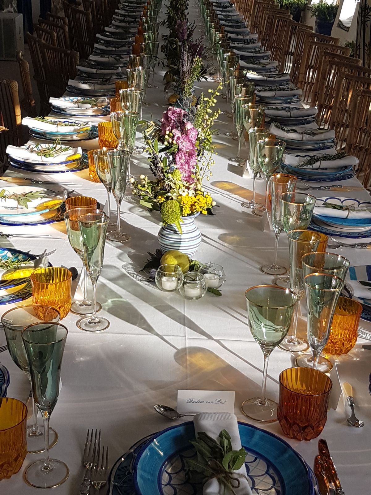 https://www.weddingamalfi.com/wp-content/uploads/Anna-and-Charles-wedding-table-colorful-decorations-with-flowers-centerpiece-and-place-cards.jpg